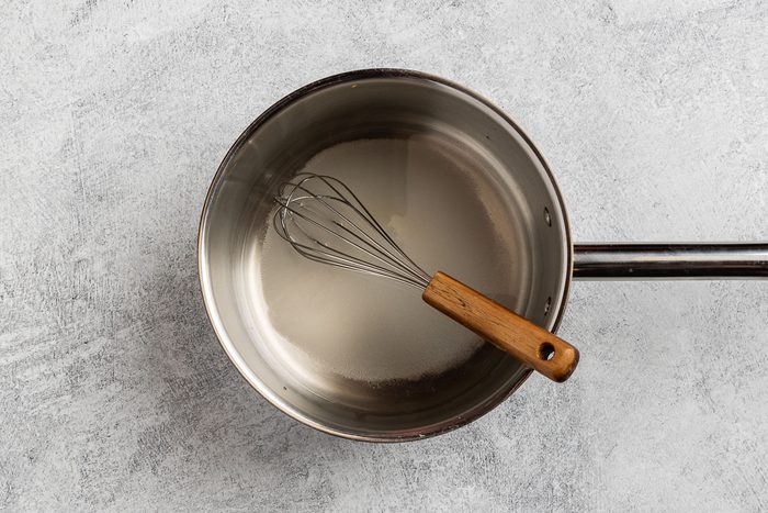 creating the simple syrup in a saucepan for the base of the sauce.