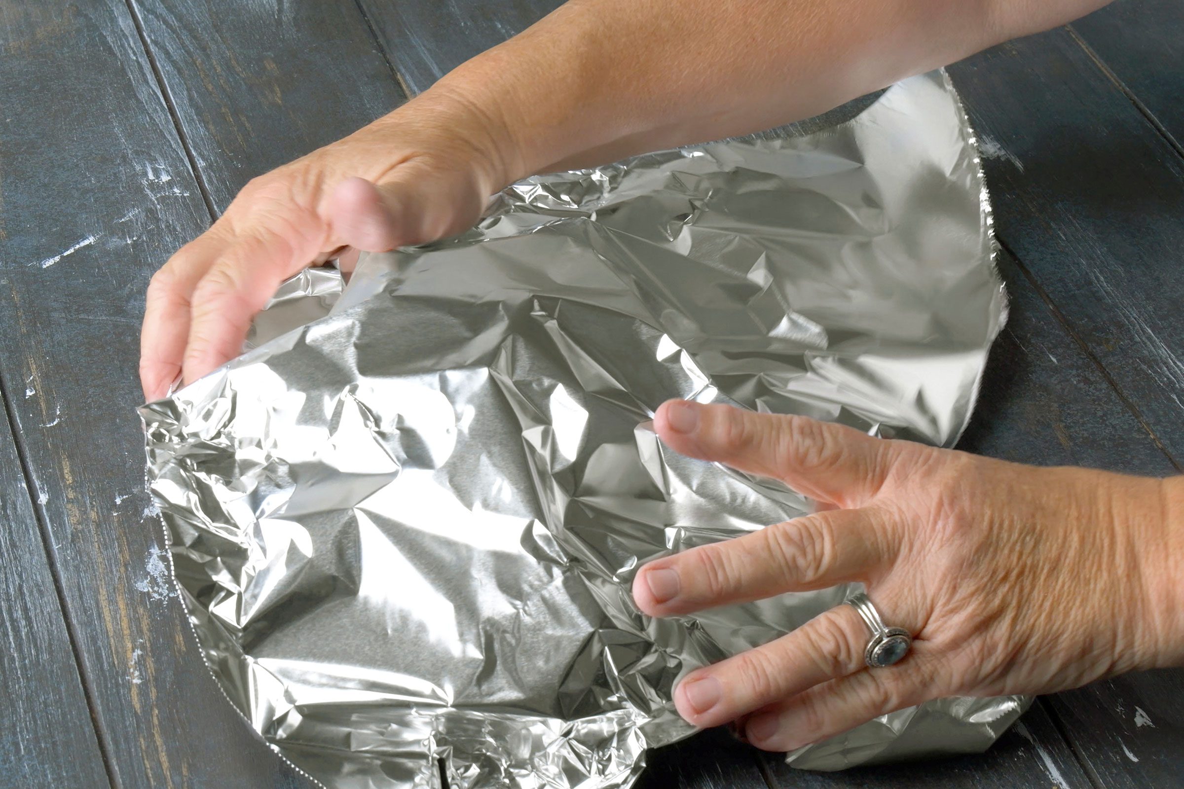 Tent with foil after baking the pork in the pan