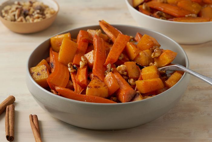 Close-up horizontal shot of the Taste of Home Roasted Vegetables with Walnuts, highlighting the caramelized edges of the vegetables and the toasted walnuts.