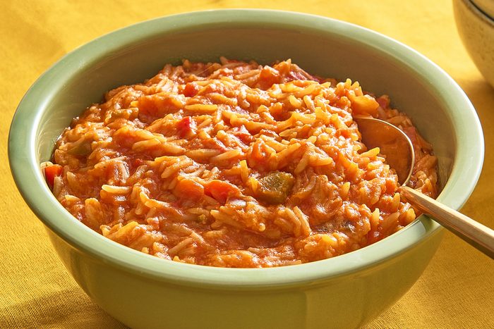 Closeup of a bowl of salsa rice being served with a spoon