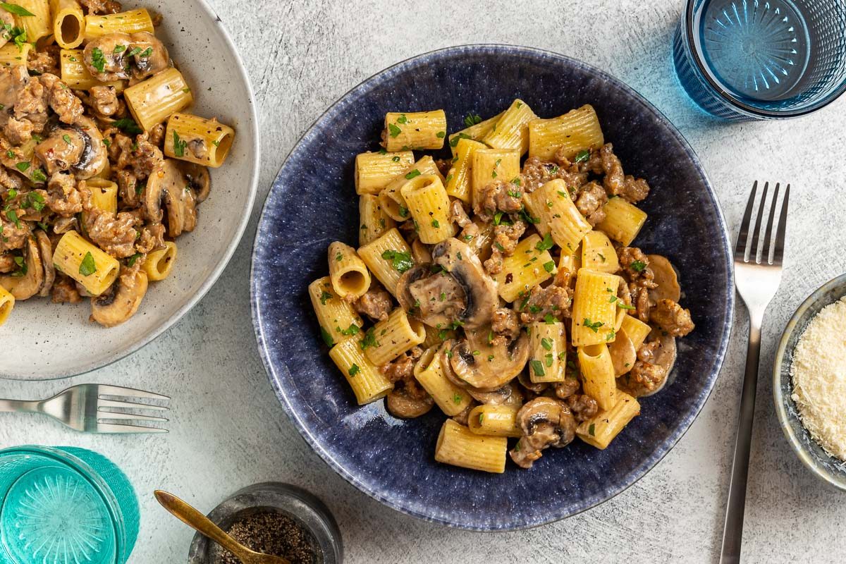 Taste of Home Sausage and Mushroom Pasta photo of the finished recipe served into pasta bowls.