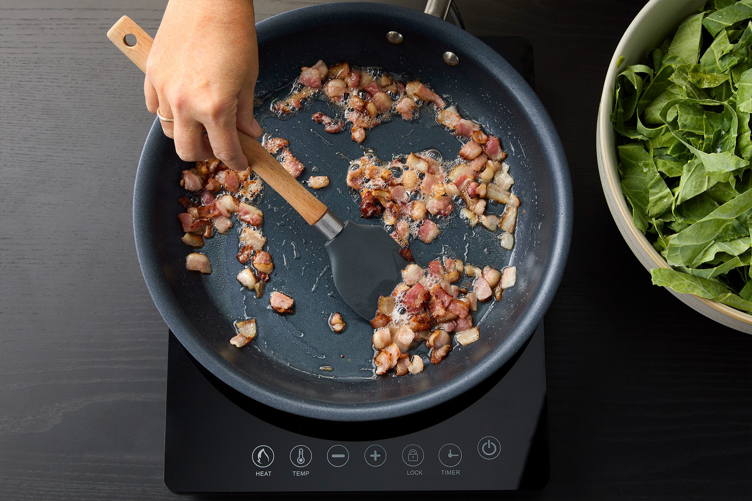Cooking bacon pieces in a large skillet to prepare Sauteed Collard Greens