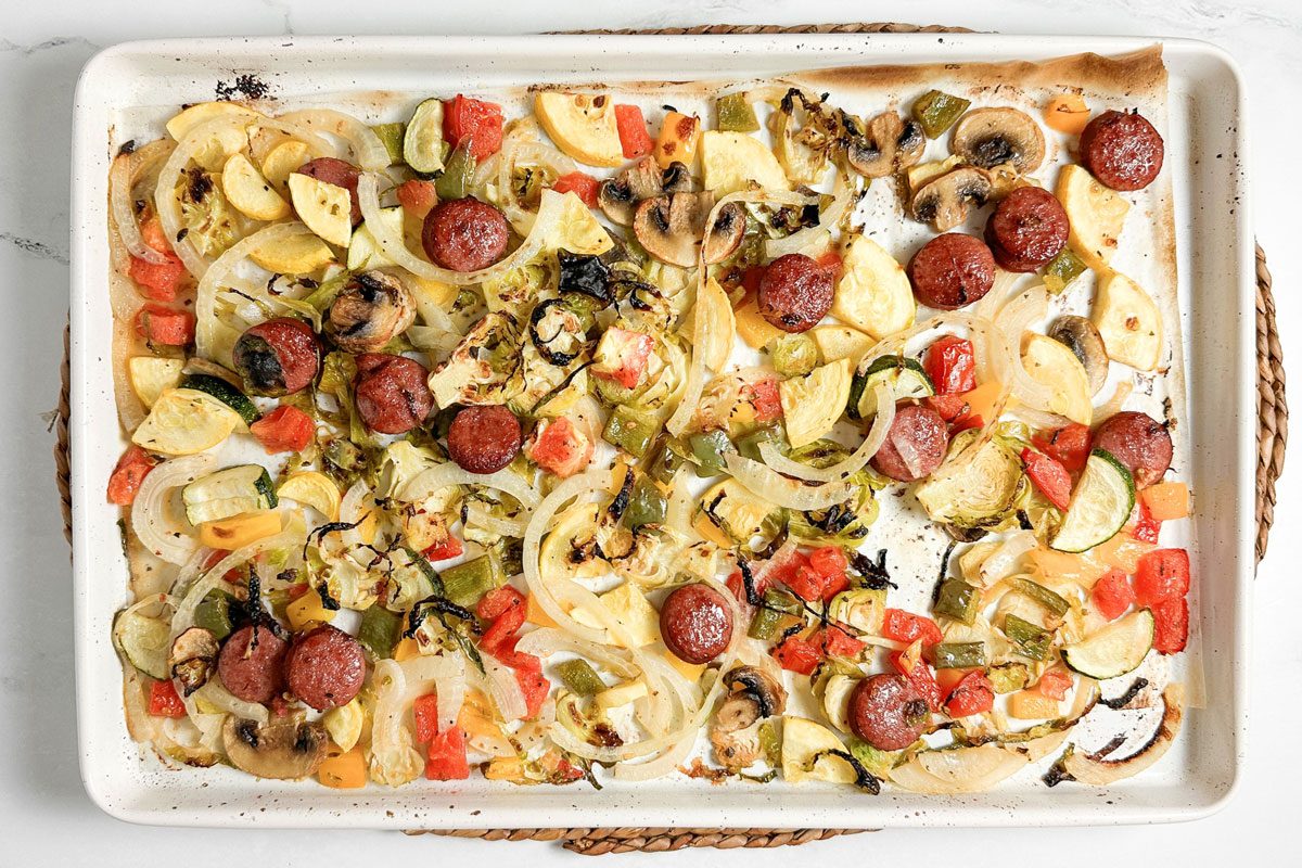 Taste of Home Sheet Pan Sausage and Veggies on a white baking sheet
