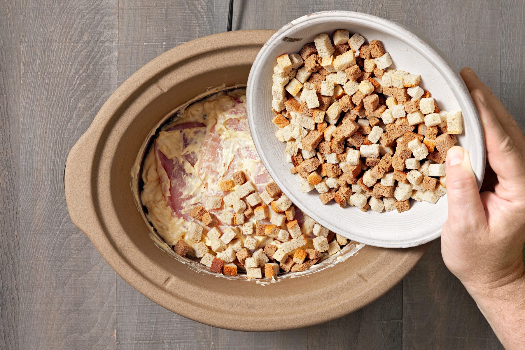 Stuffing cubes are sprinkled on top.