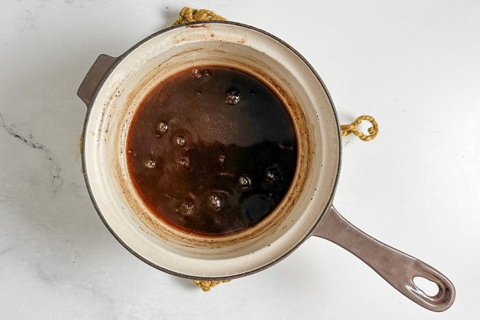 Syrup for Taste of Home Spiced Pears in a ceramic saucepan