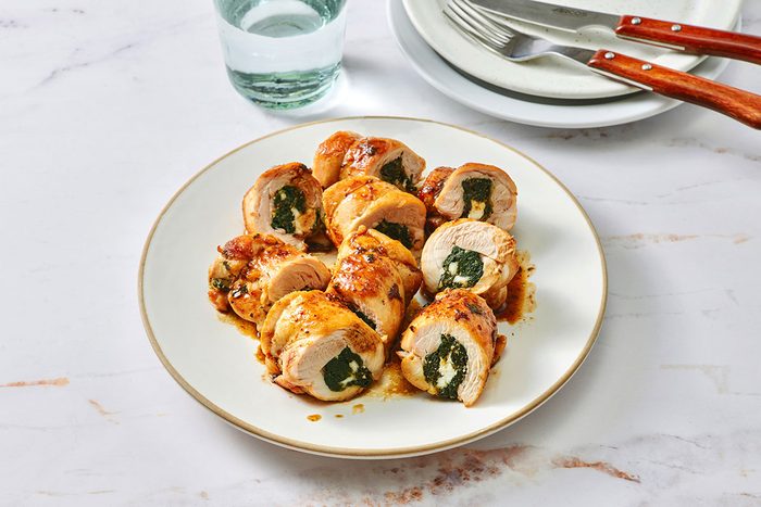 Spinach and feta stuffed chicken on a serving platter