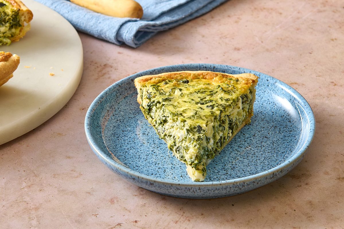 Closeup of a single slice of spinach pie on a plate