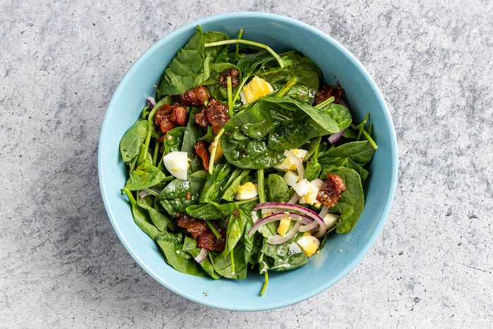 assembled spinach salad in a bowl