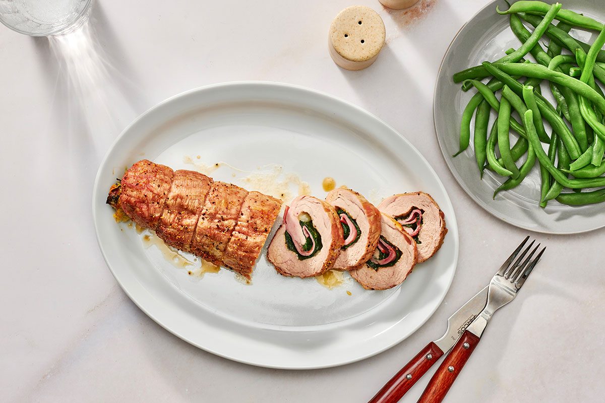 Cooked pork tenderloin on a serving platter