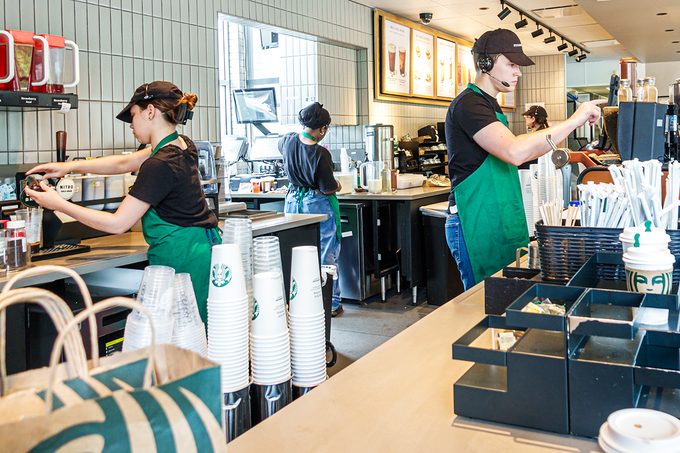 Starbucks' baristas working on drinks.