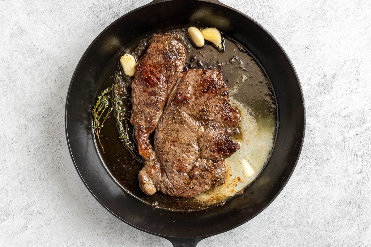 steak cooked in a skillet.