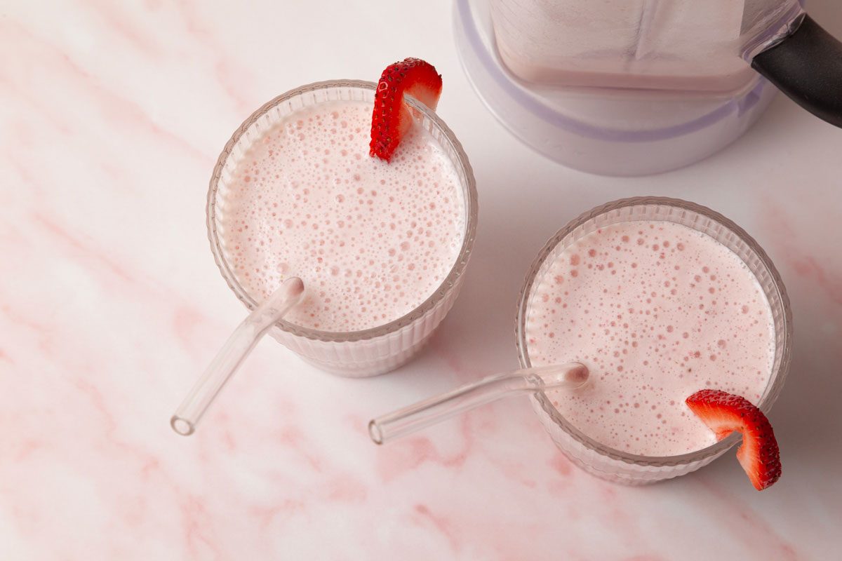 Taste of Home Strawberry Pineapple Smoothies garnished with strawberry slices