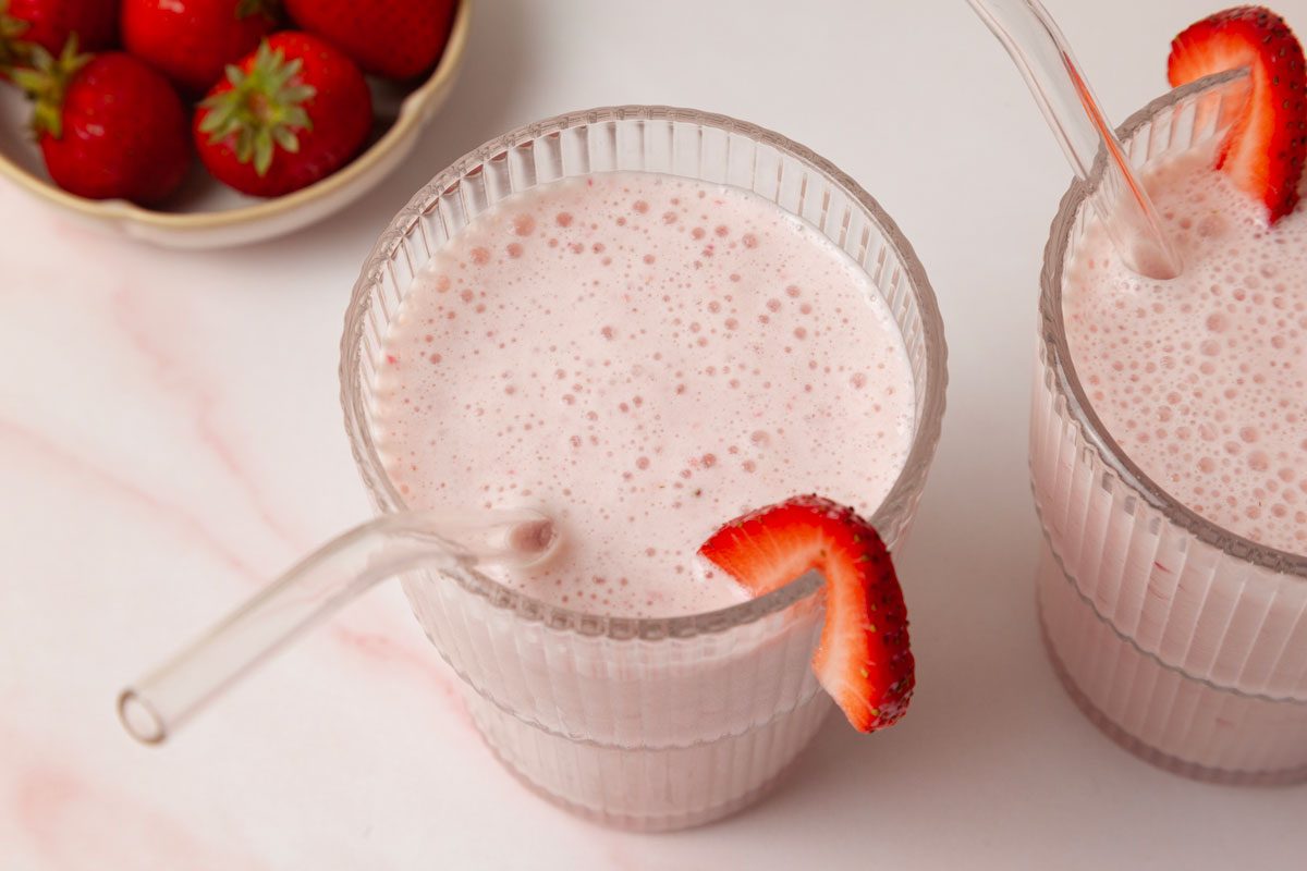 Taste of Home Strawberry Pineapple Smoothies garnished with strawberry slices