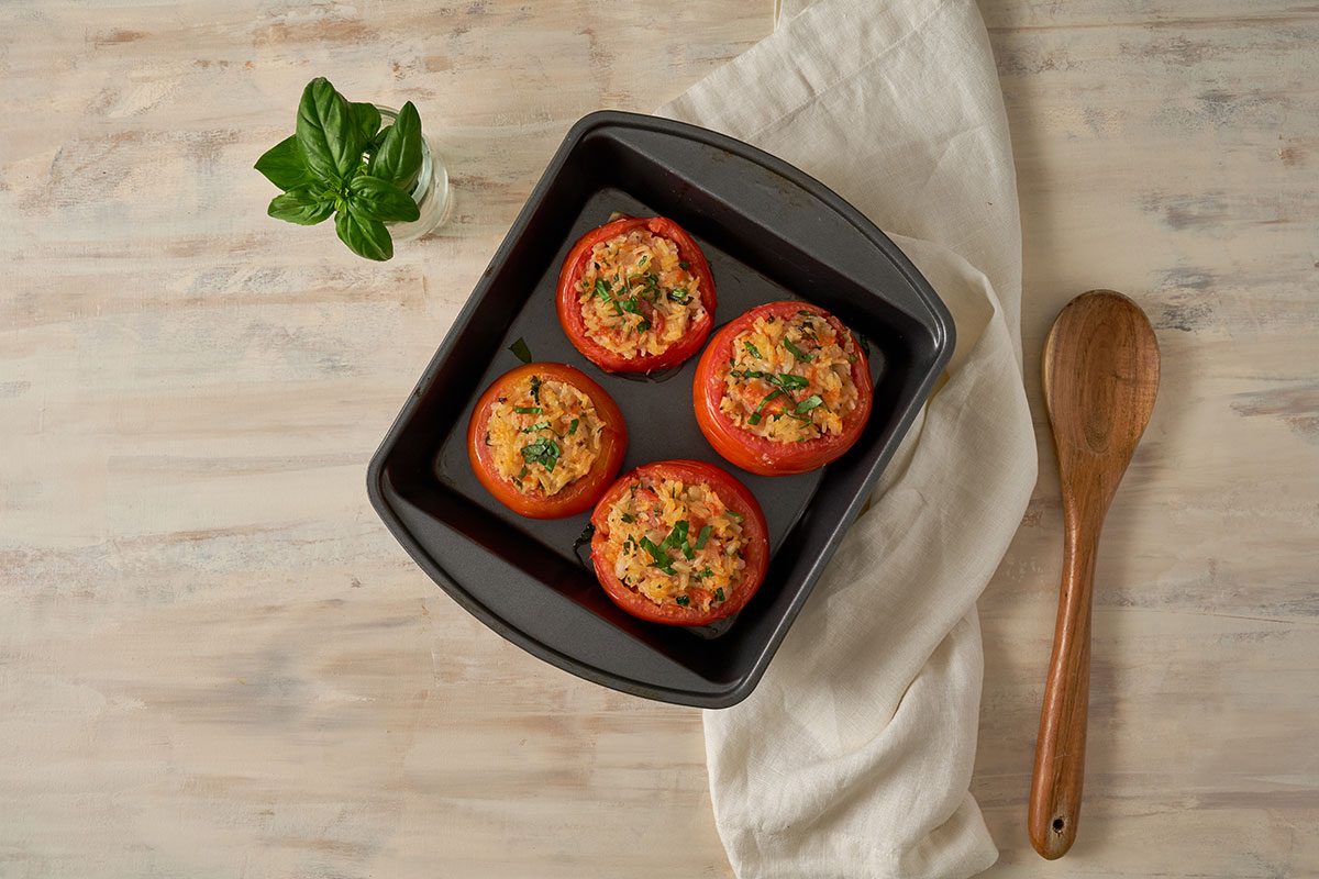 An overhead view of the finished stuffed tomatoes with rice, golden and crispy on top, served warm from the oven for the Stuffed Tomatoes with Rice recipe, by Taste of Home.