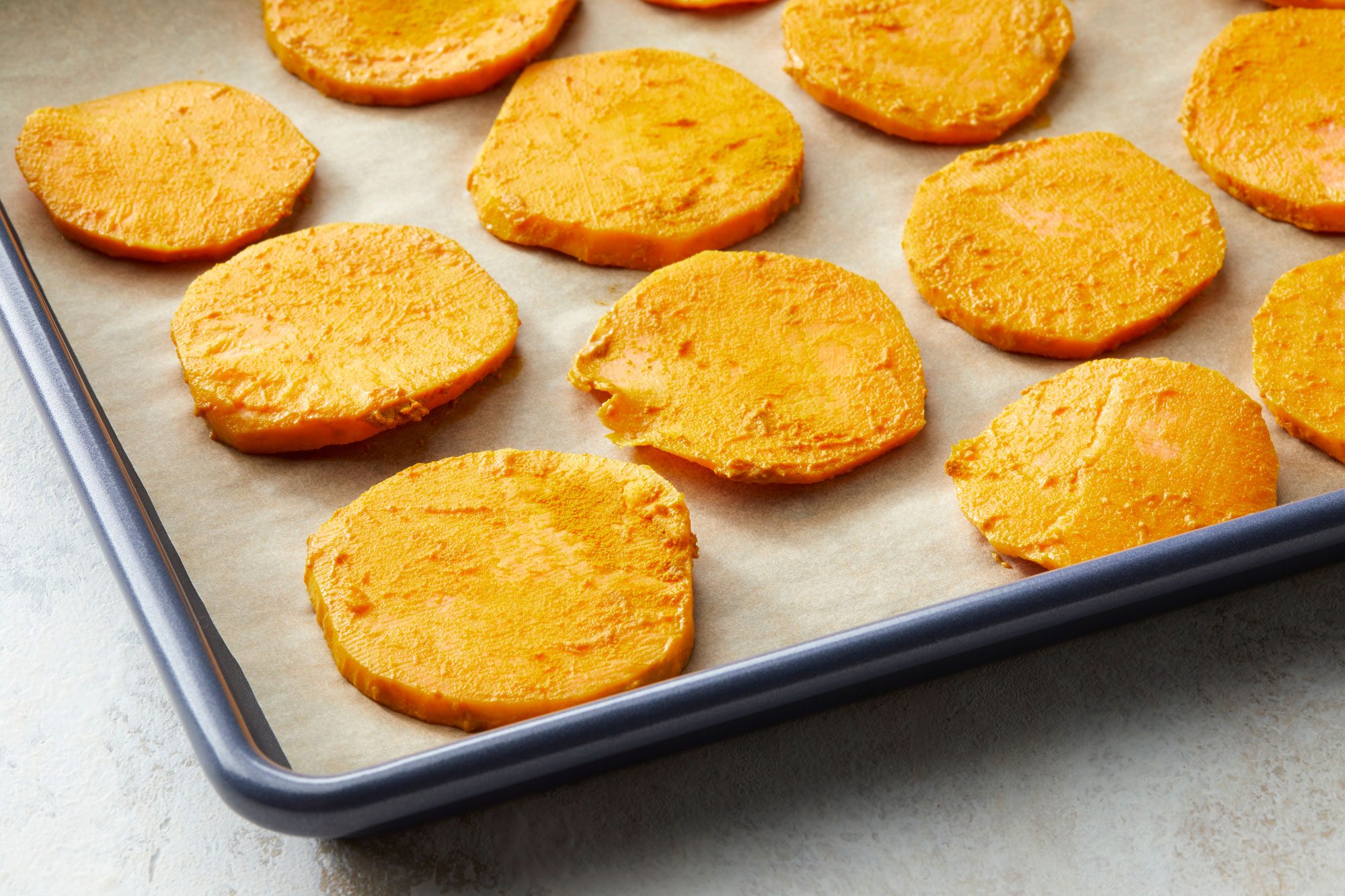 Spread the potato slices in a single layer on the prepared baking sheet