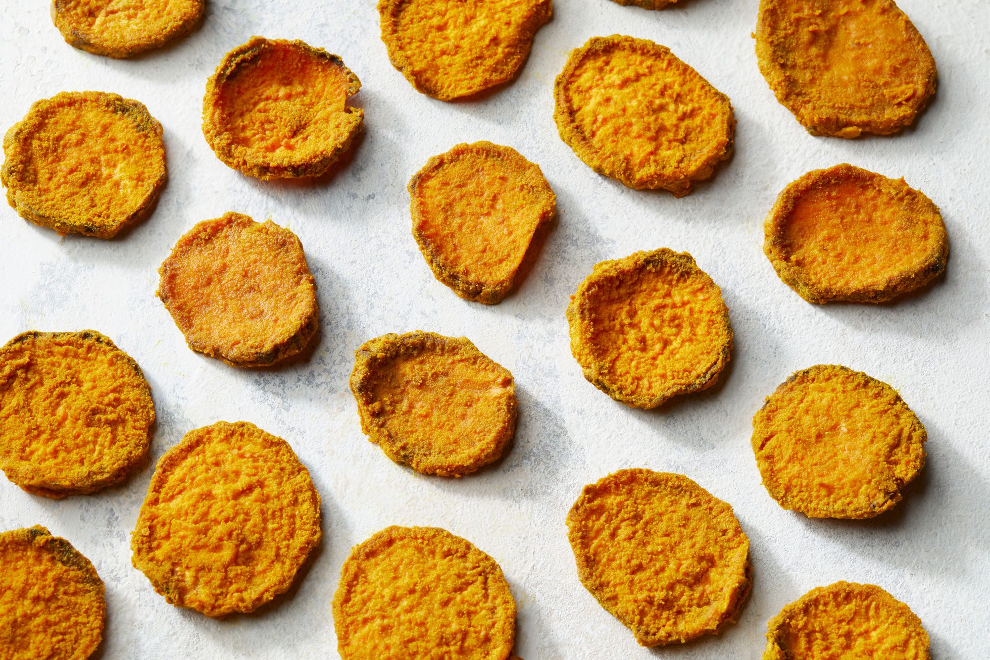 Sweet Potato Dog Treats placed on the baking sheet