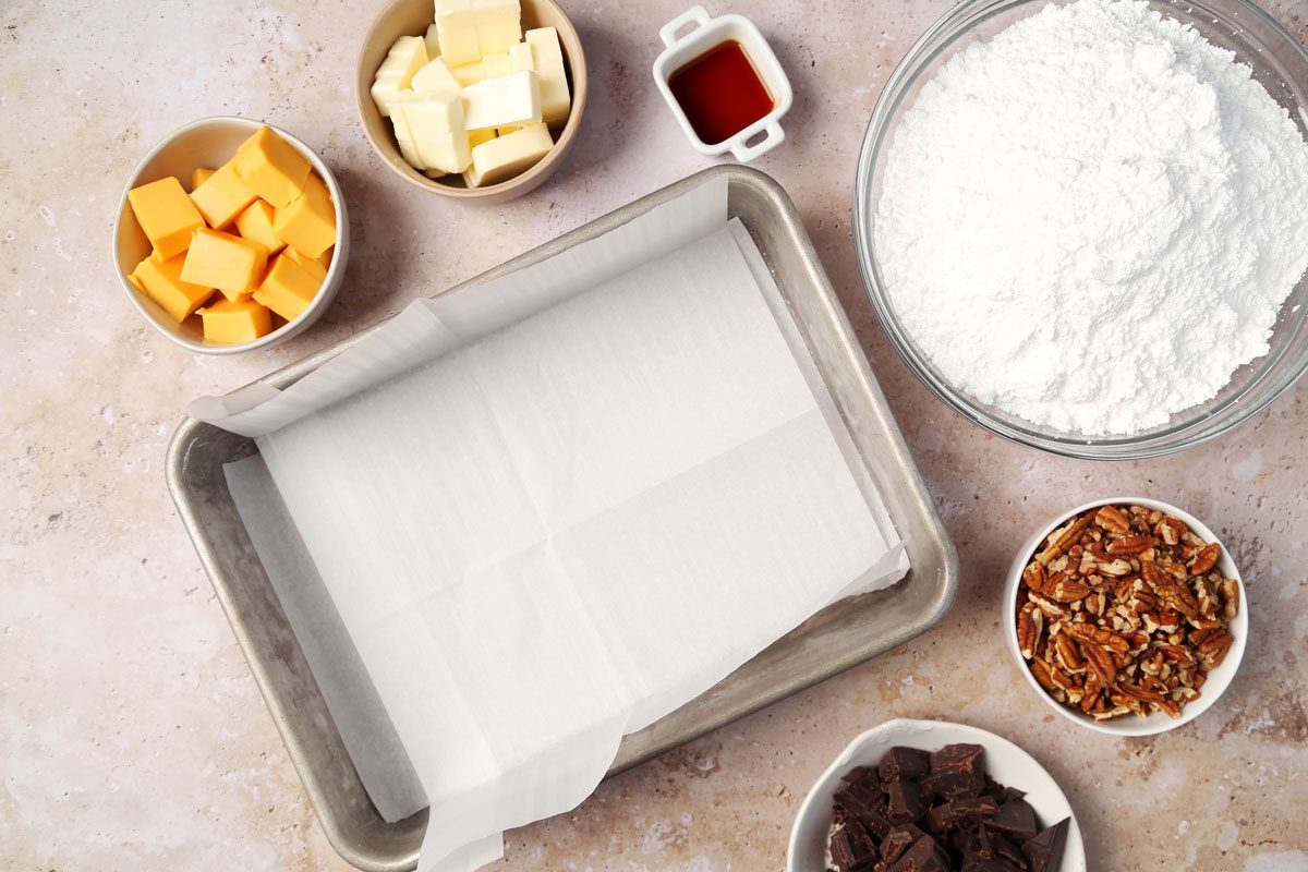 Process of making Taste of Home's Velveeta Fudge in a large mixing bowl on a brown marble surface.