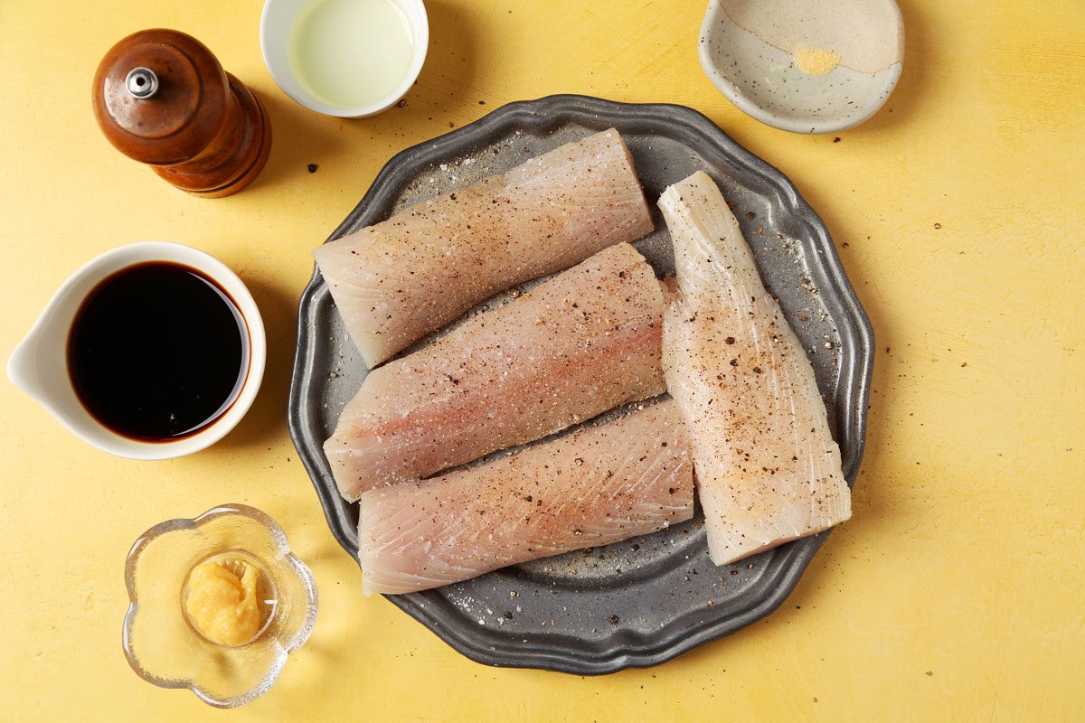 Process of making Taste of Home's Teriyaki Mahi Mahi laid out in small bowls on bright yellow surface.