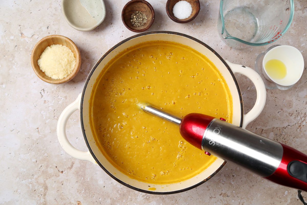 Process of making Taste of Home's butternut squash and sweet potato soup laid out on a brown marble surface.