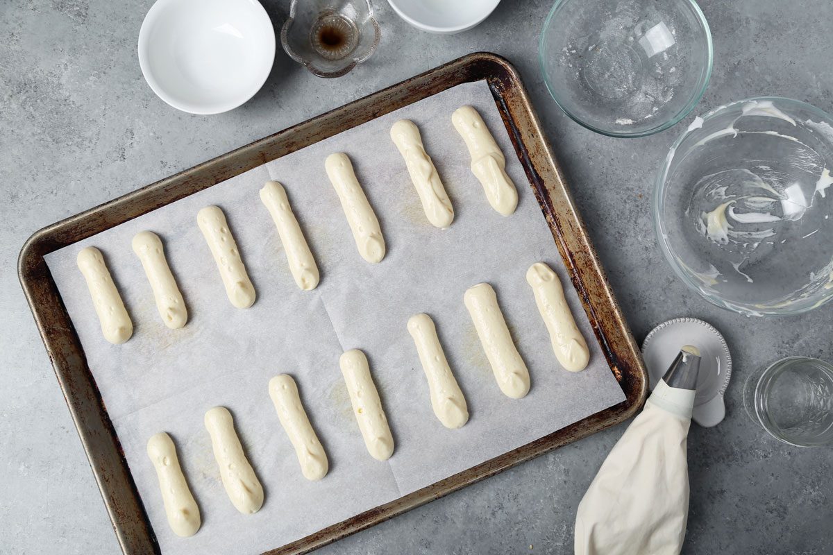 Process of making Taste of Home's Lady Fingers on a baking sheet on a wire rack.