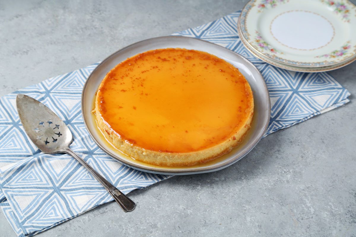 Process of making Taste of Home's Flan de Queso. Flan overturned on a plate on a grey surface.