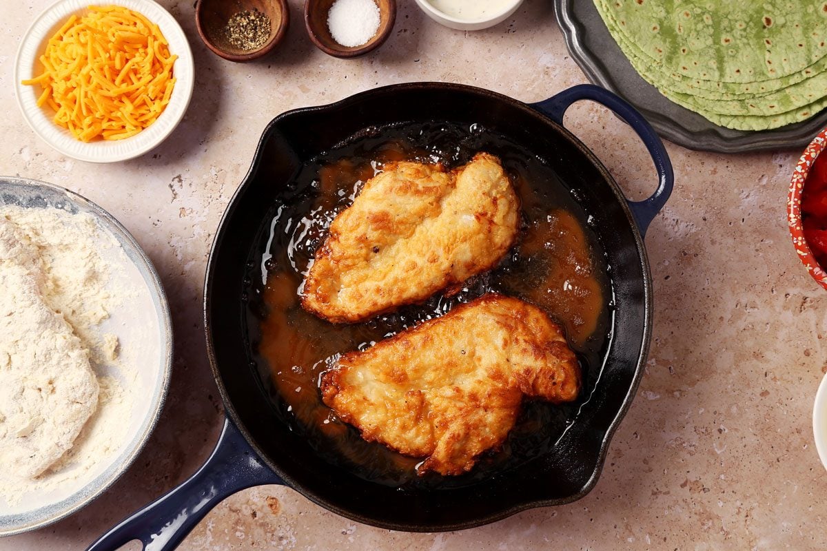 Process of making Taste of Home's Buffalo Chicken Wrap. Chicken being fried in a skillet.