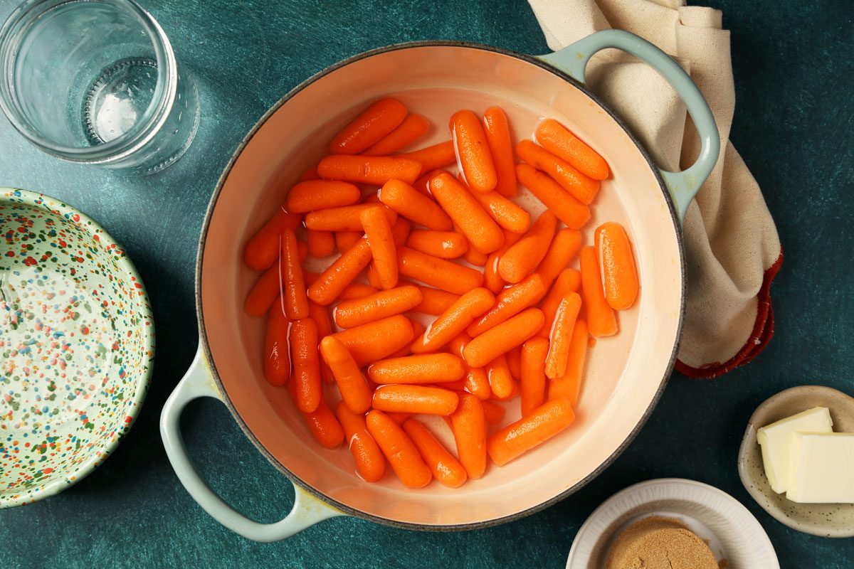 Process of making Taste of Home's Glazed Carrots served on a large dish with a green surface.