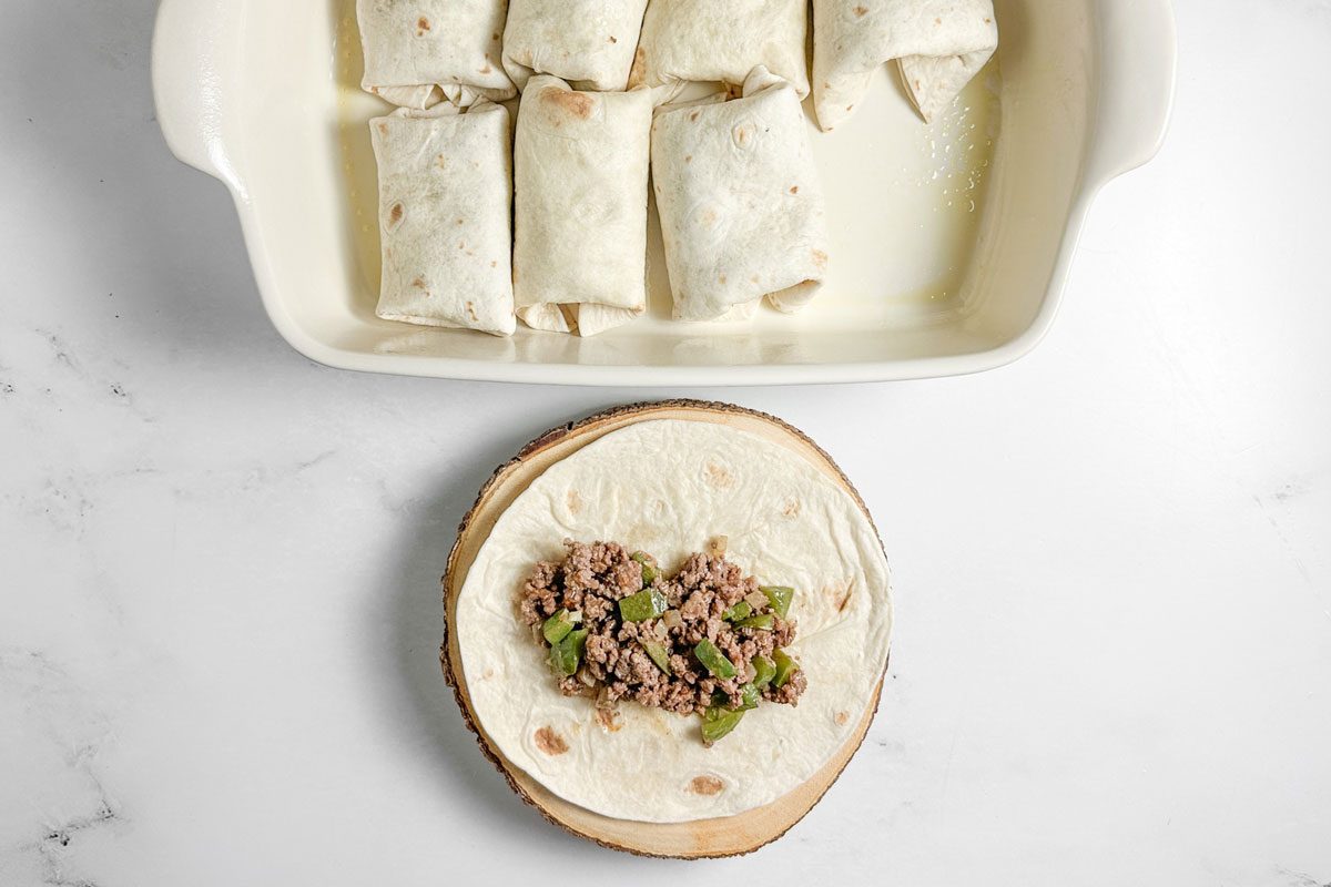 Assembled burritos for Taste of Home Taco Burrito in a white baking dish