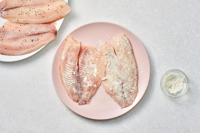 Seasoned tilapia fillets on a plate