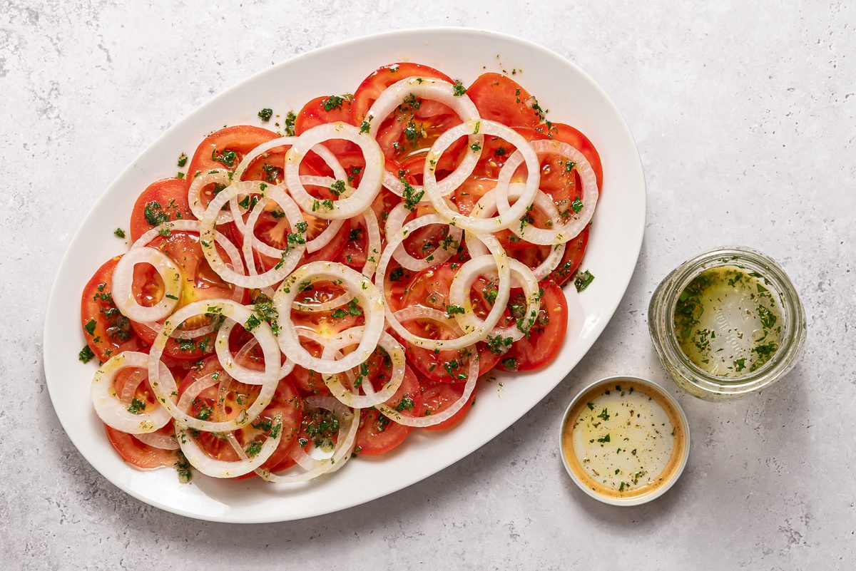 Oval Plate With Sliced Onions, Tomatoes And Seasoning