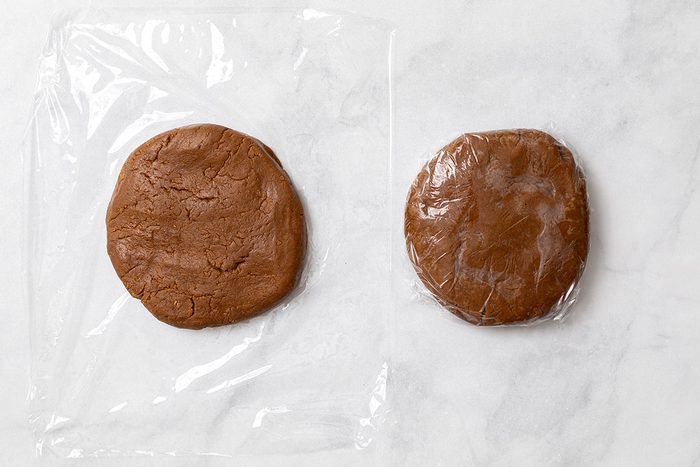 Divided gingerbread cookie dough wrapped in plastic wrap for step three of Wookie Cookie recipe for Taste of Home