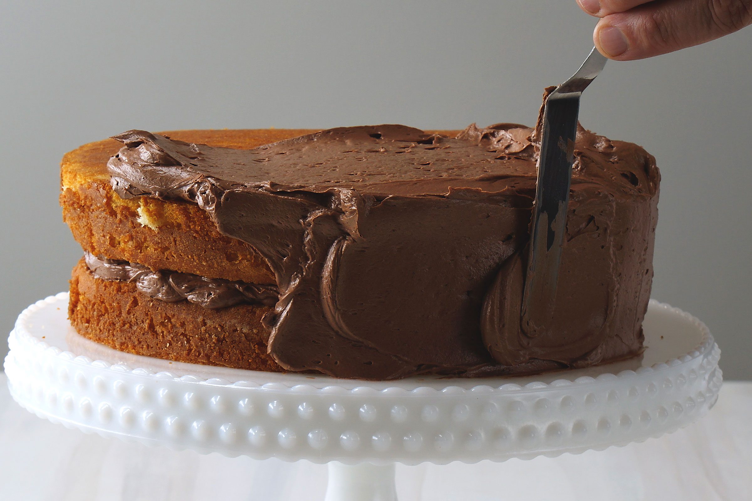 Chocolate frosting on yellow cake