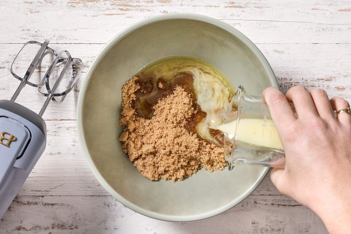 In a large bowl, beat together sugar and butter.