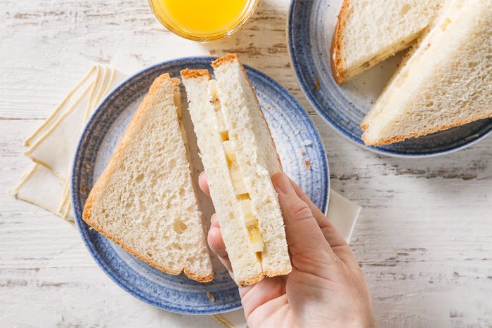 overhead shot of banana sandwich served with juice