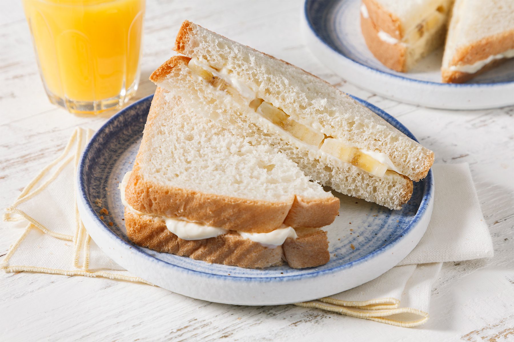 high angle shot of banana sandwich served with juice