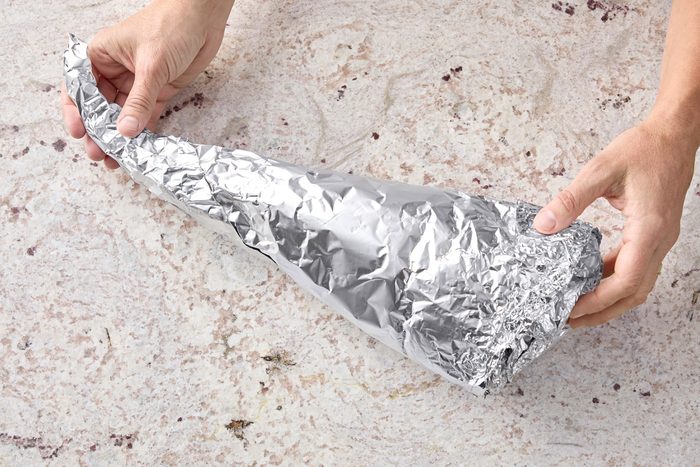 Curve pointed end to one side to create cornucopia shape.