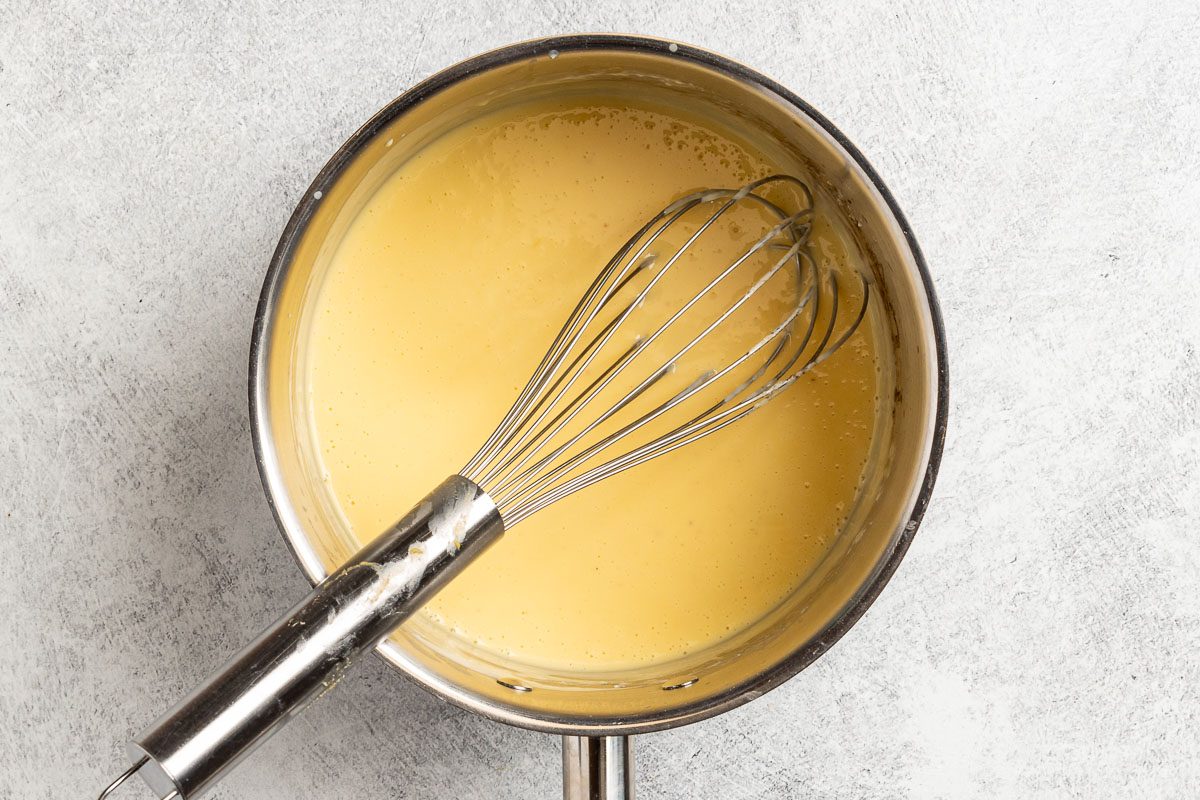 Taste of Home Cheesy Peas photo of adding the cheese to the sauce.