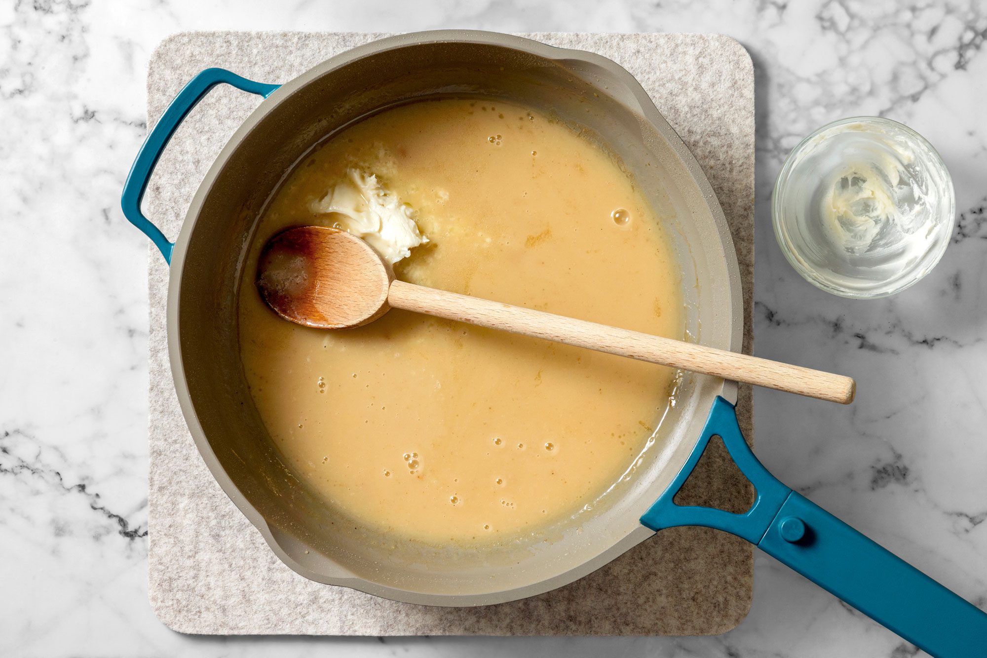In a small bowl, combine softened butter and flour to form a paste then add to skillet.