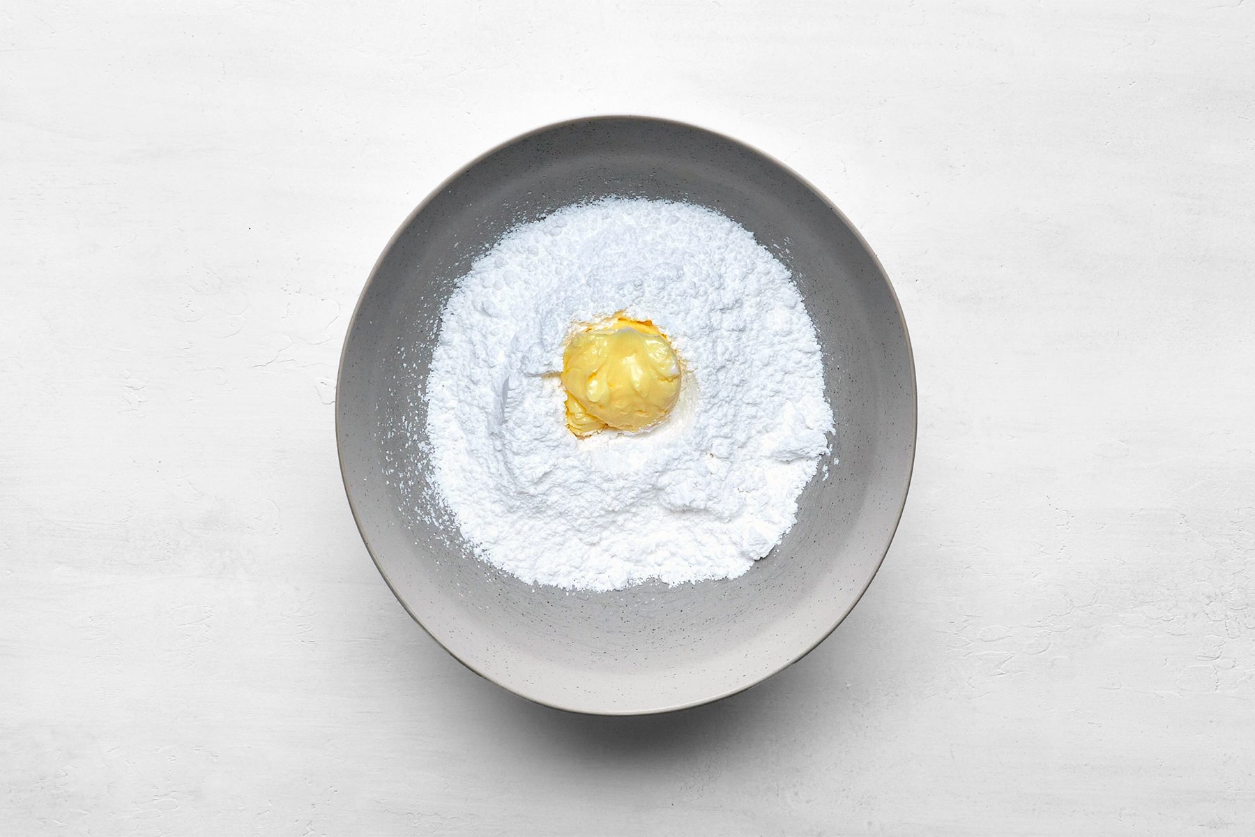 In a small bowl, combine confectioners' sugar, butter, milk and extract