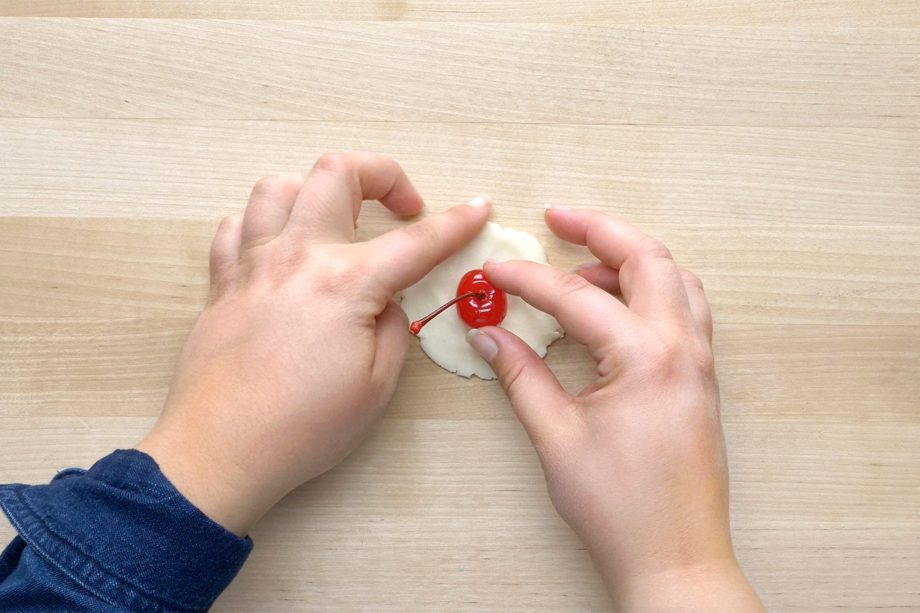 Wrap 1 circle around each cherry and lightly roll in hands.