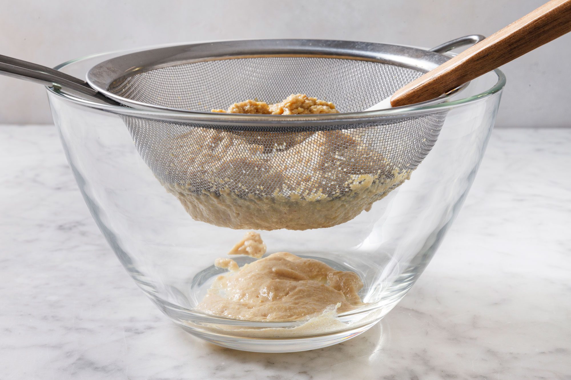 press firmly on the solids with a spoon or spatula to extract as much dijon mustard as possible