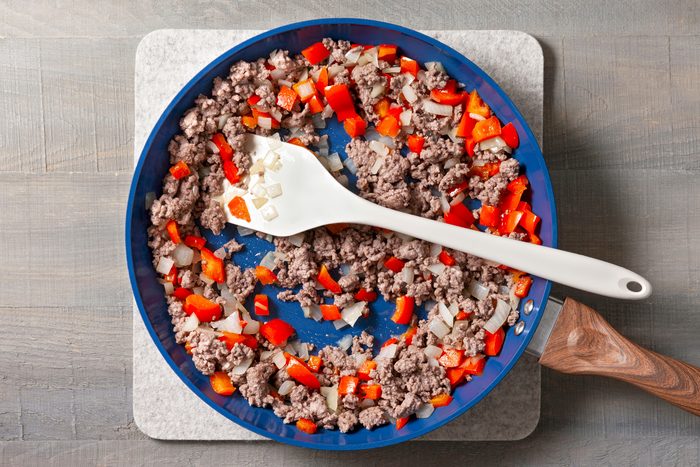 In a large skillet, cook ground beef, red pepper, and onion over medium heat until the beef is browned.