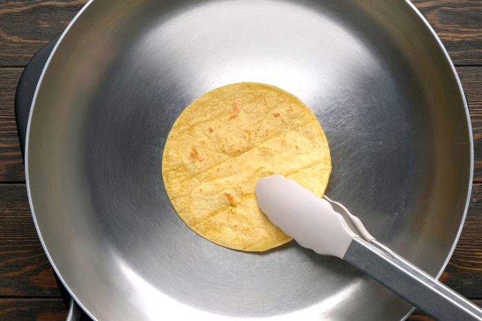 Toasting a tortilla in a dry large skillet