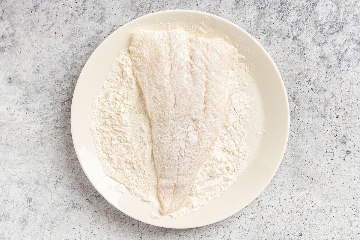 Taste of Home Fried Cod Fish photo of dredging the cod in flour.