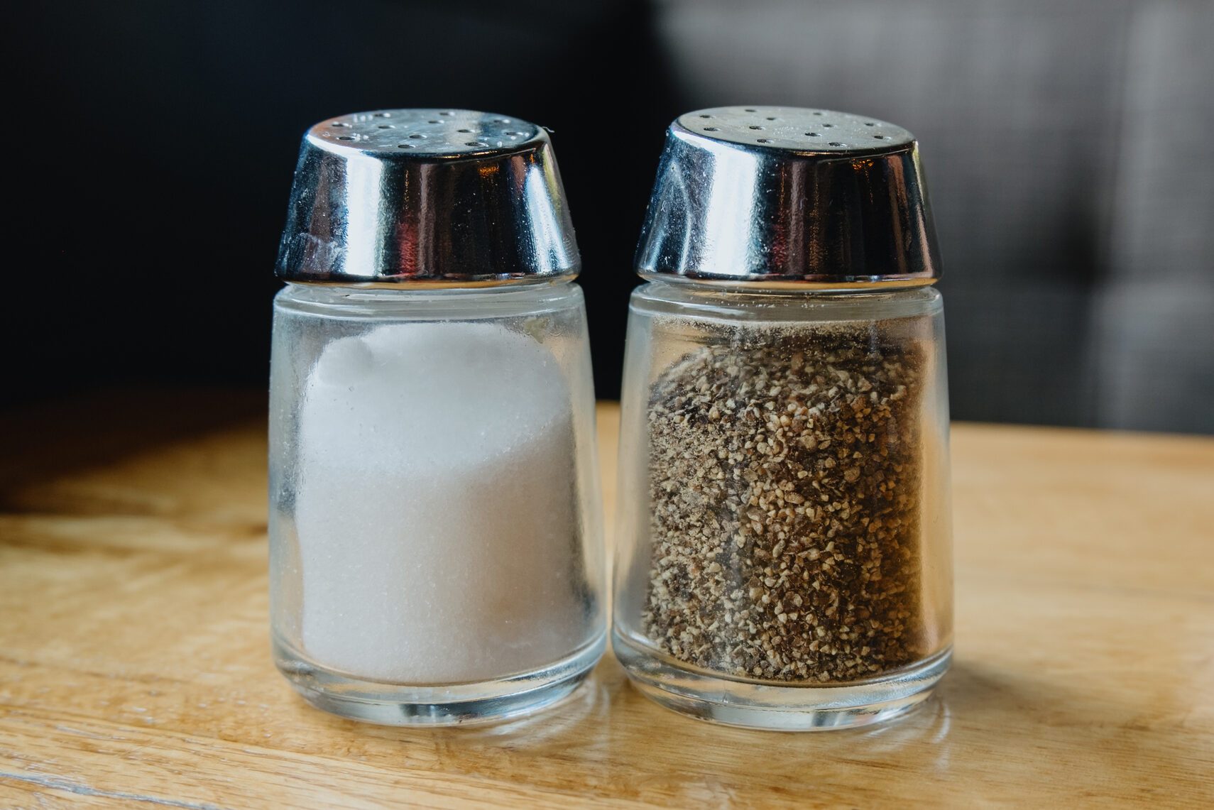 Salt and Pepper Shakers on Table at Restaurant