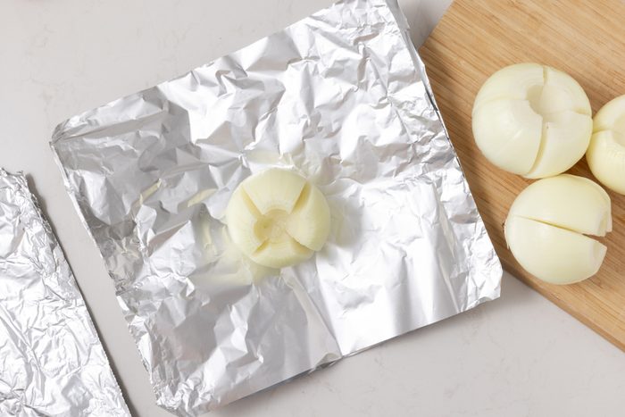 Onions being placed on heavy-duty foil.
