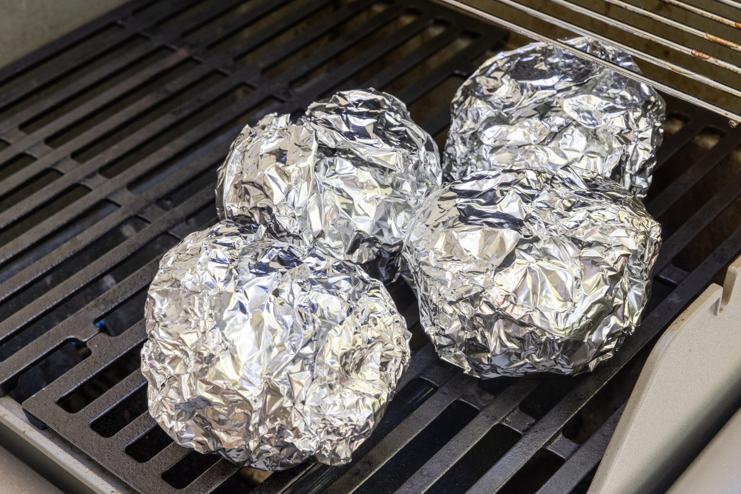 Onions being grilled in indirect heat.