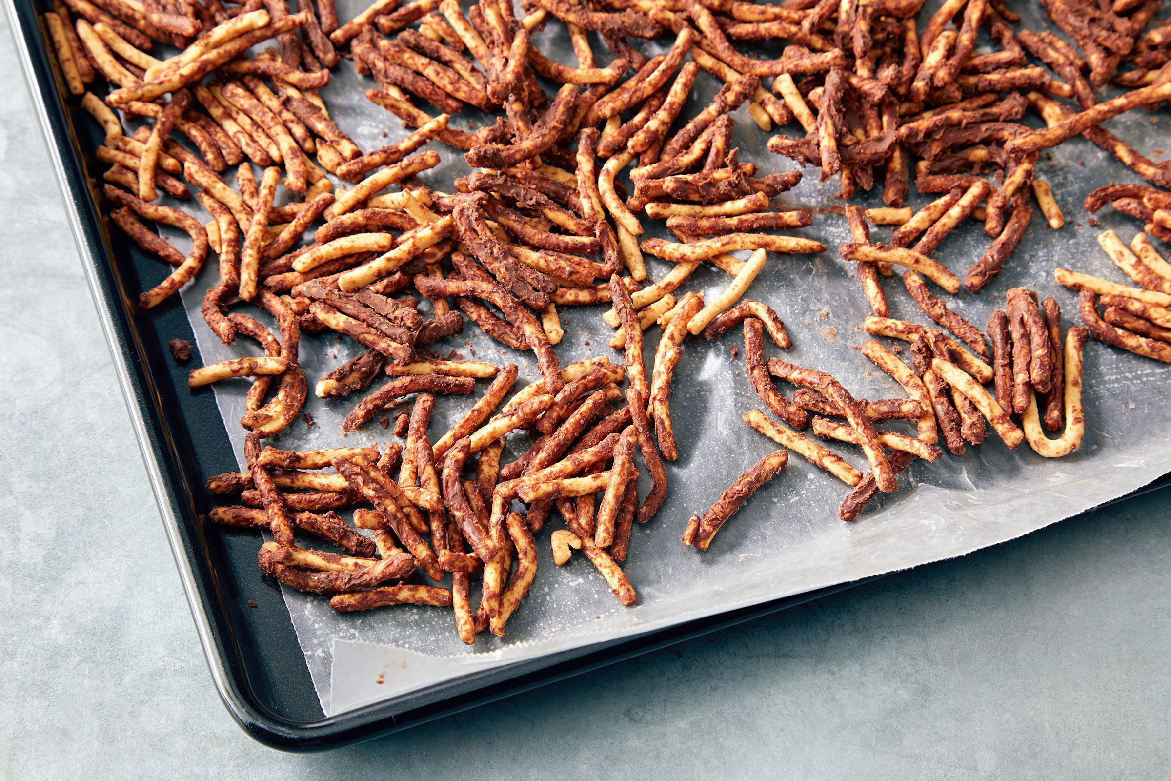 Chocolate coated noodles on a waxed paper lined sheet