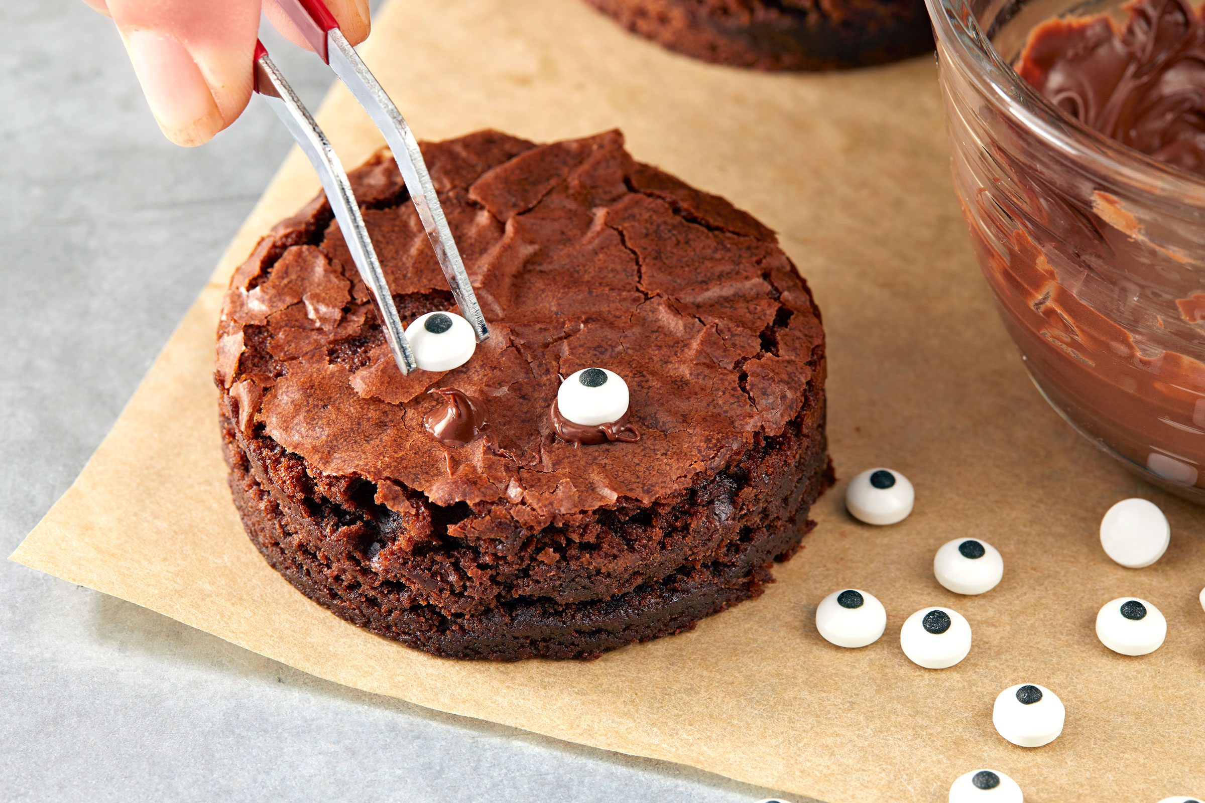 Attaching eyeballs to brownie piece