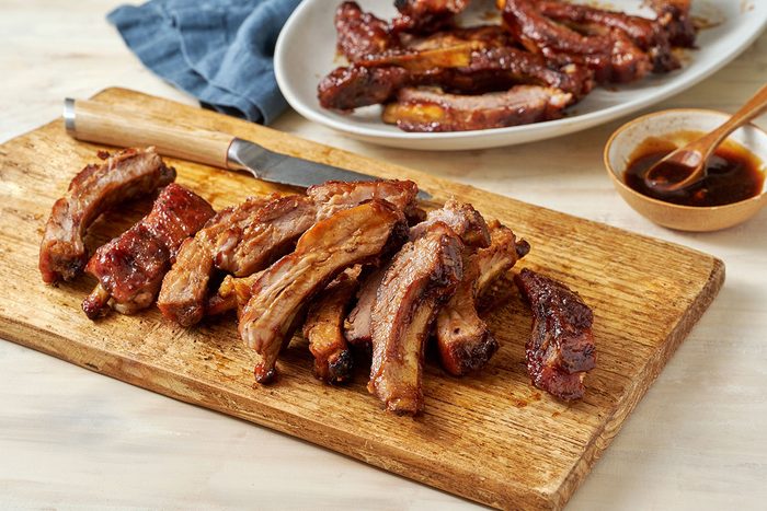 Close-up horizontal shot of the Taste of Home Honey Garlic Ribs, highlighting the caramelized edges and glossy honey garlic sauce coating.